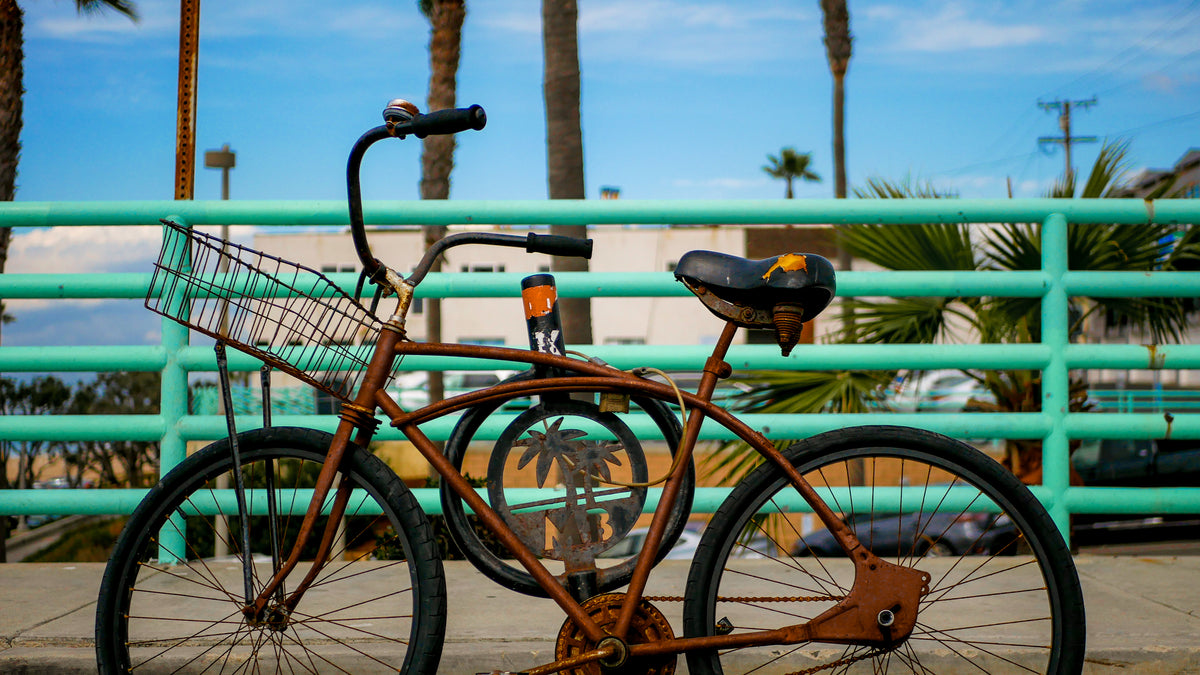 rusty bike parked on boardwalk
