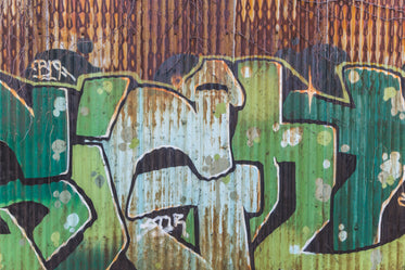 rusty green tin graphitti wall