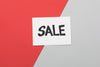 sale sign on angled pink gray background