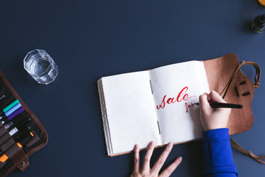 sale written in red pen on notebook