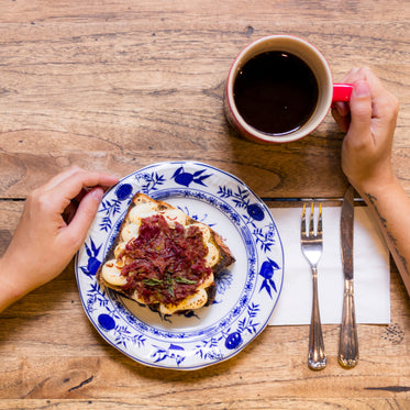 sandwich on plate and cup of coffee