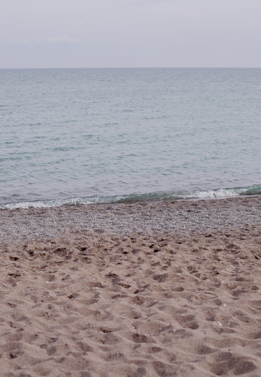 sandy beach and wavy ocean on a overcast day