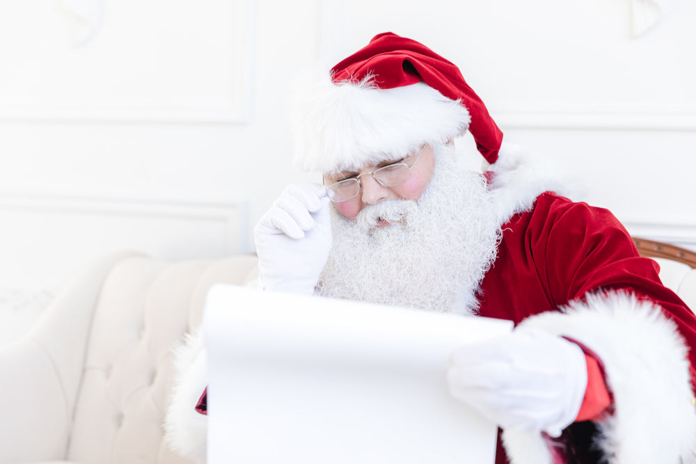 santa examines his naughty or nice list