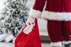santa holds his bag of toys