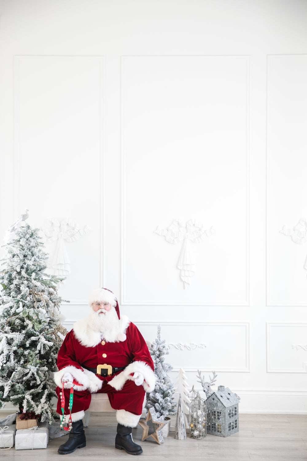 santa sits by tree