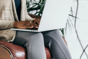 sat on leather chair using laptop