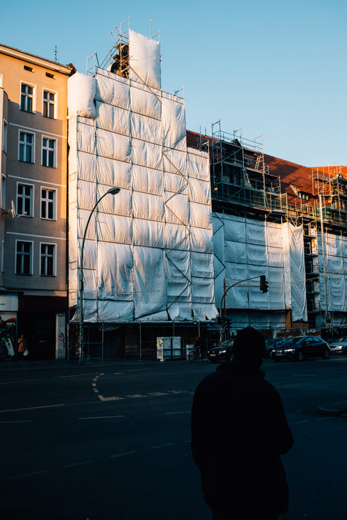 scaffolding by a building covered in white cloth
