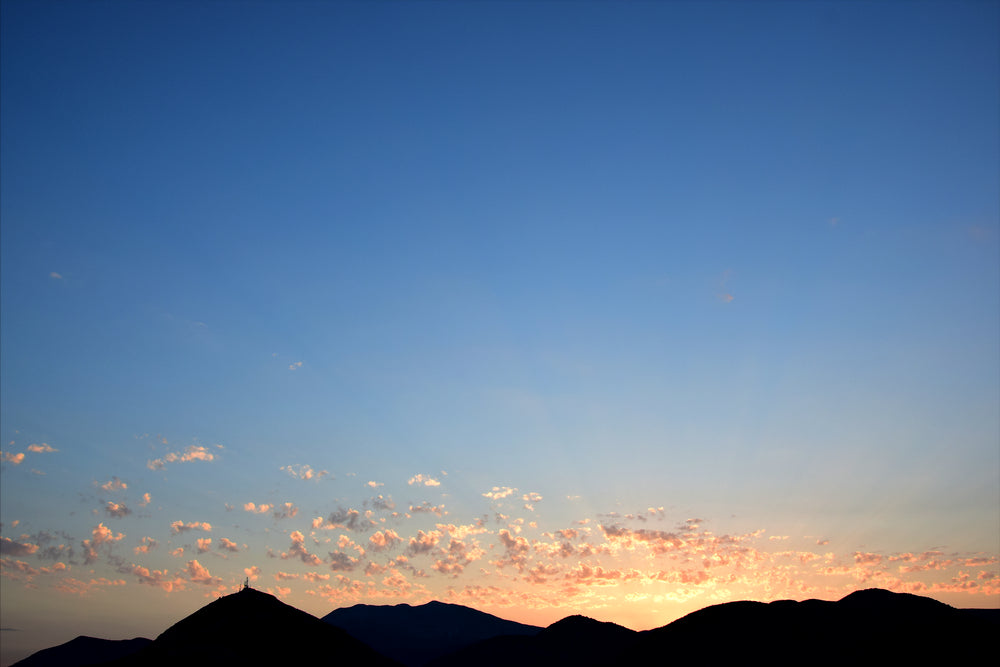 scattered clouds light up at sunset