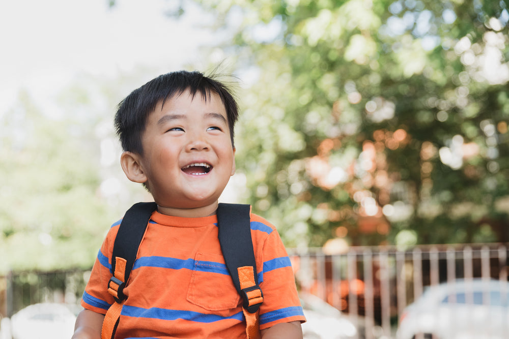 school child giggles in the sun