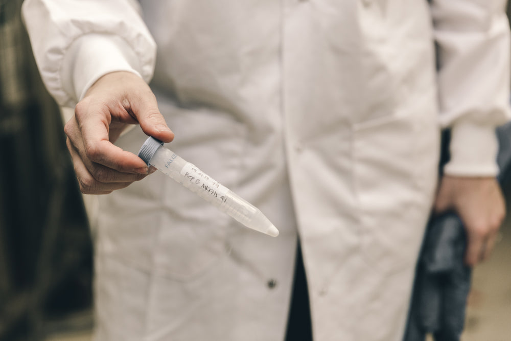 scientist holding frozen test tube