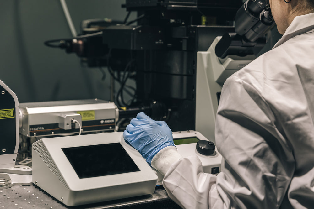 scientist in lab with microscope