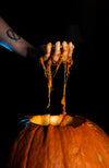 scooping guts out of a pumpkin