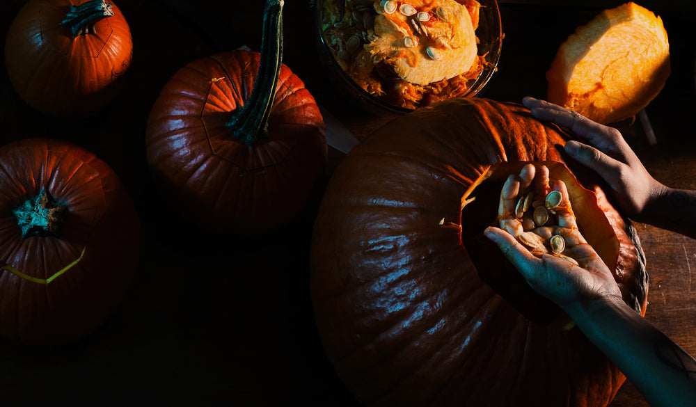 scooping seeds out of a pumpkin