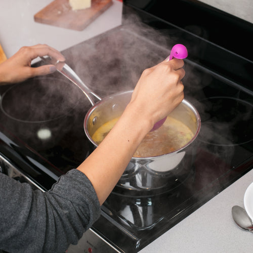 Scooping Soup On Stove