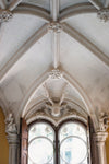 sculpted ceiling over ornate windows
