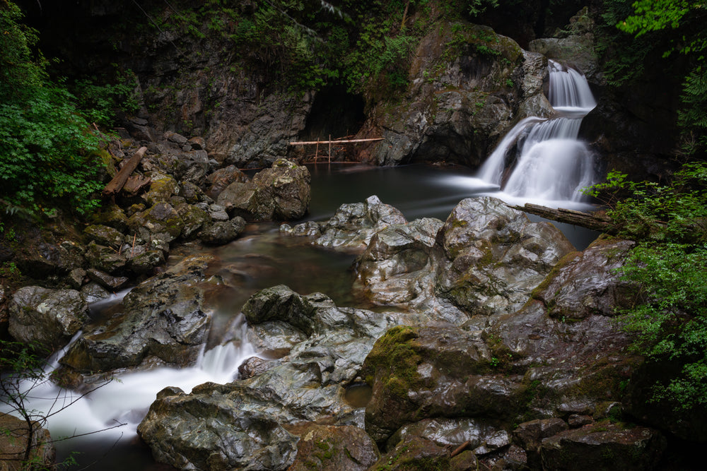 sculpted rocks cradle tranquil pool and waterfalls