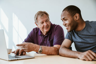 senior teaching young man