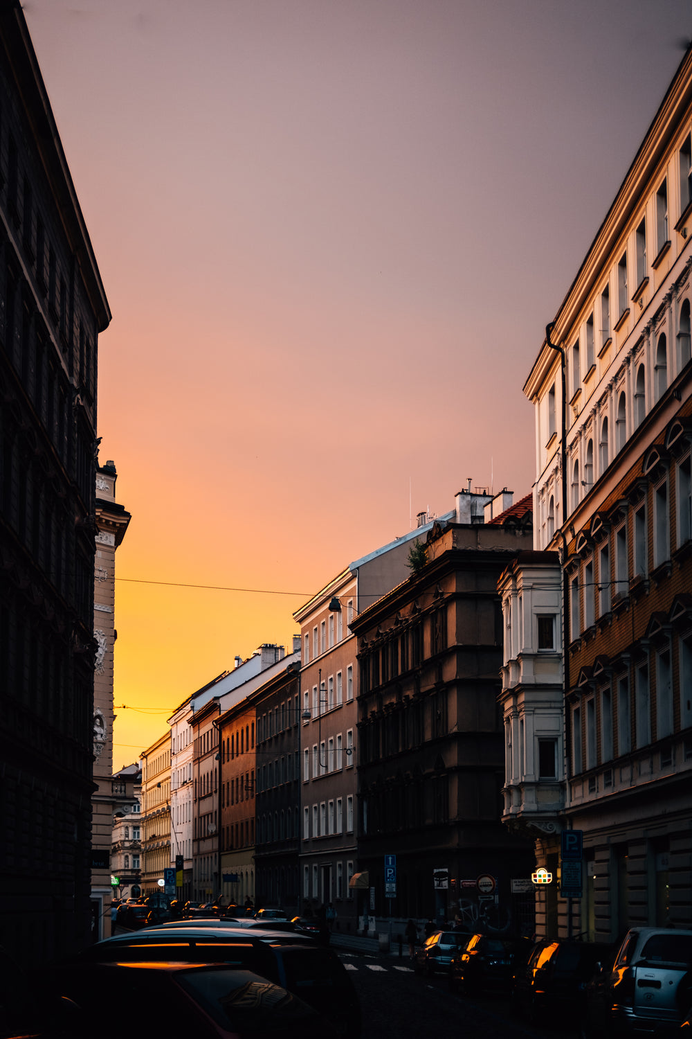 setting sun with golden sky over city