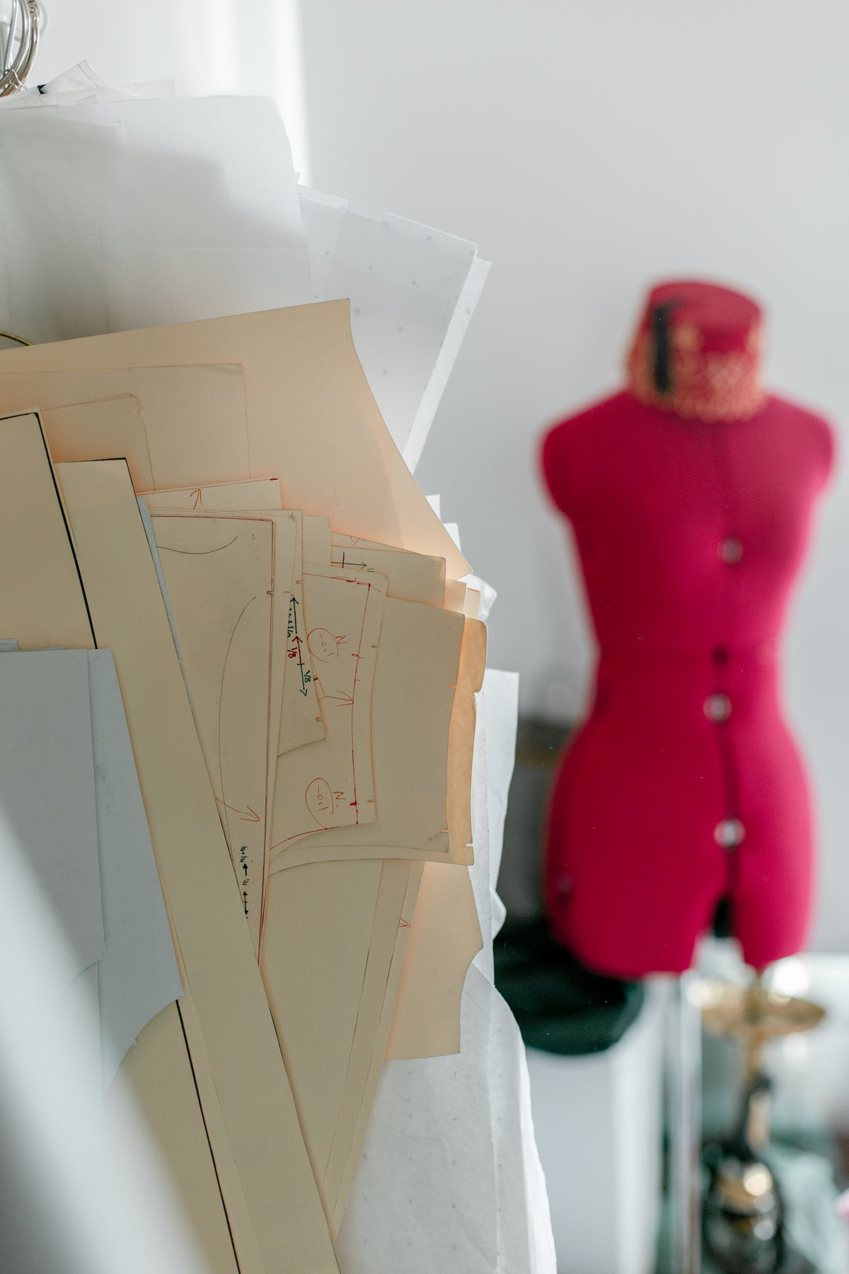 sewing patterns and a pink mannequin