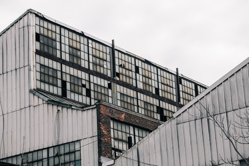 shattered windows in grey buildings