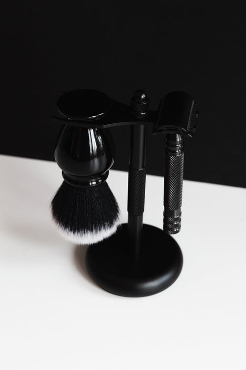 shaving kit in stand on black and white