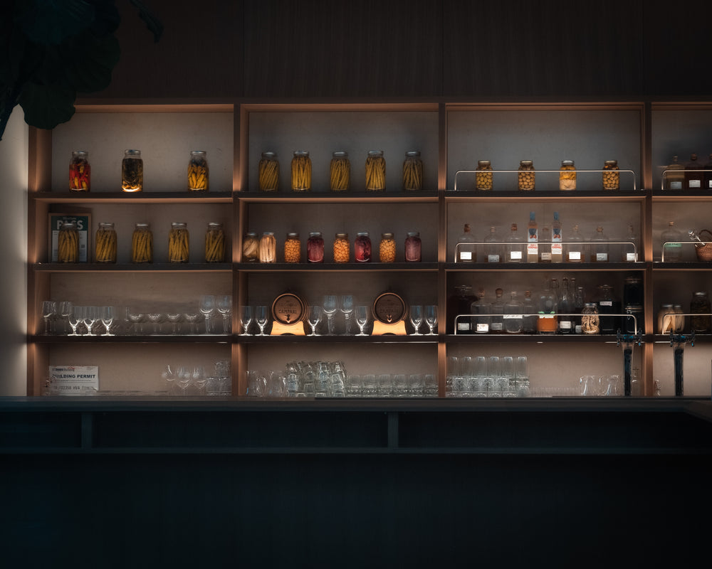 shelves filled with glassware and jars of preserves