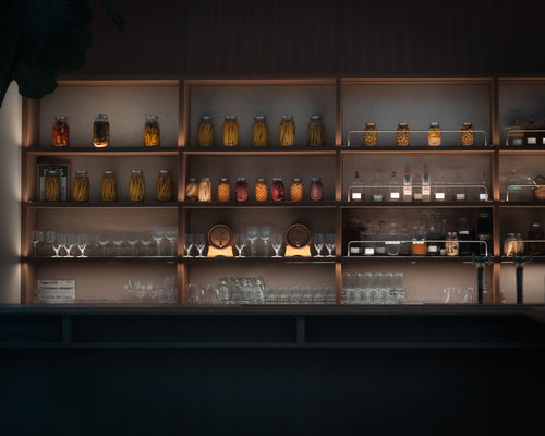 shelves filled with glassware and jars of preserves