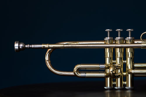 shiny trumpet musical instrument with valves and mouthpiece