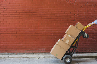 shipping boxes in front of red brick