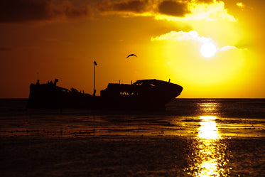 shipwreck silhouette at sunset