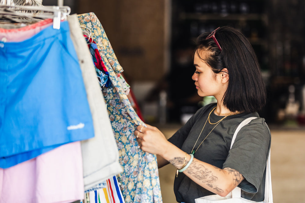 shopper in clothing store browsing merchandise