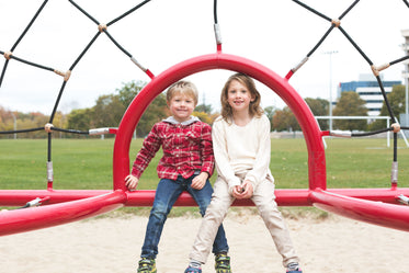 siblings smiling at park