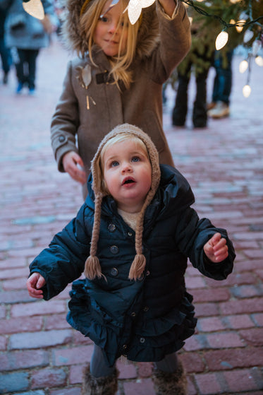 siblings play in festive decorations