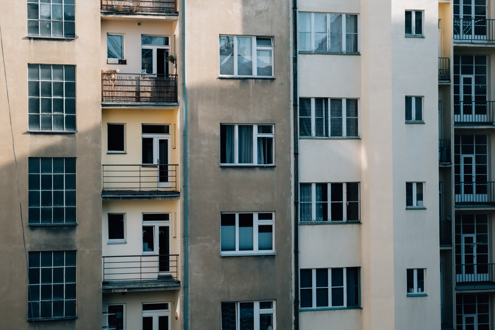 side of a building with large windows and small balconies