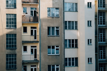 side of a building with large windows and small balconies