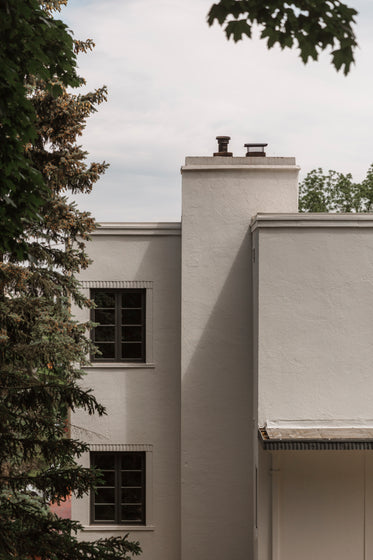 side of beige buildings with two windows