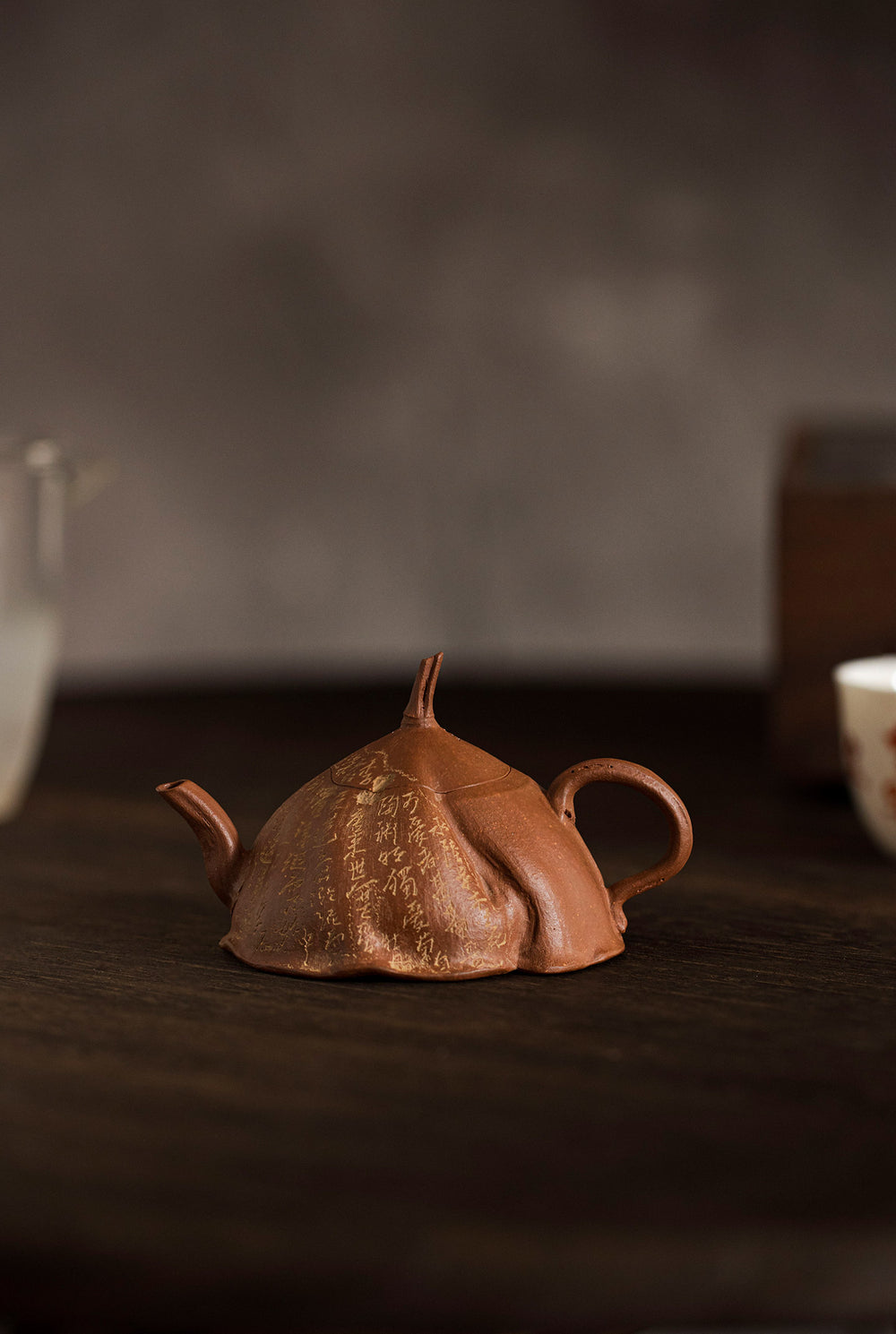 side view of a rust colored teapot