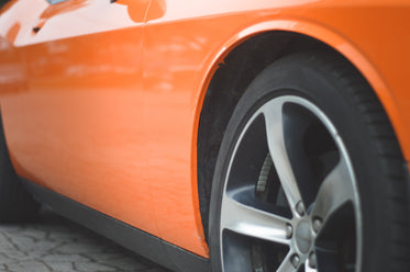 side view of an orange sports car