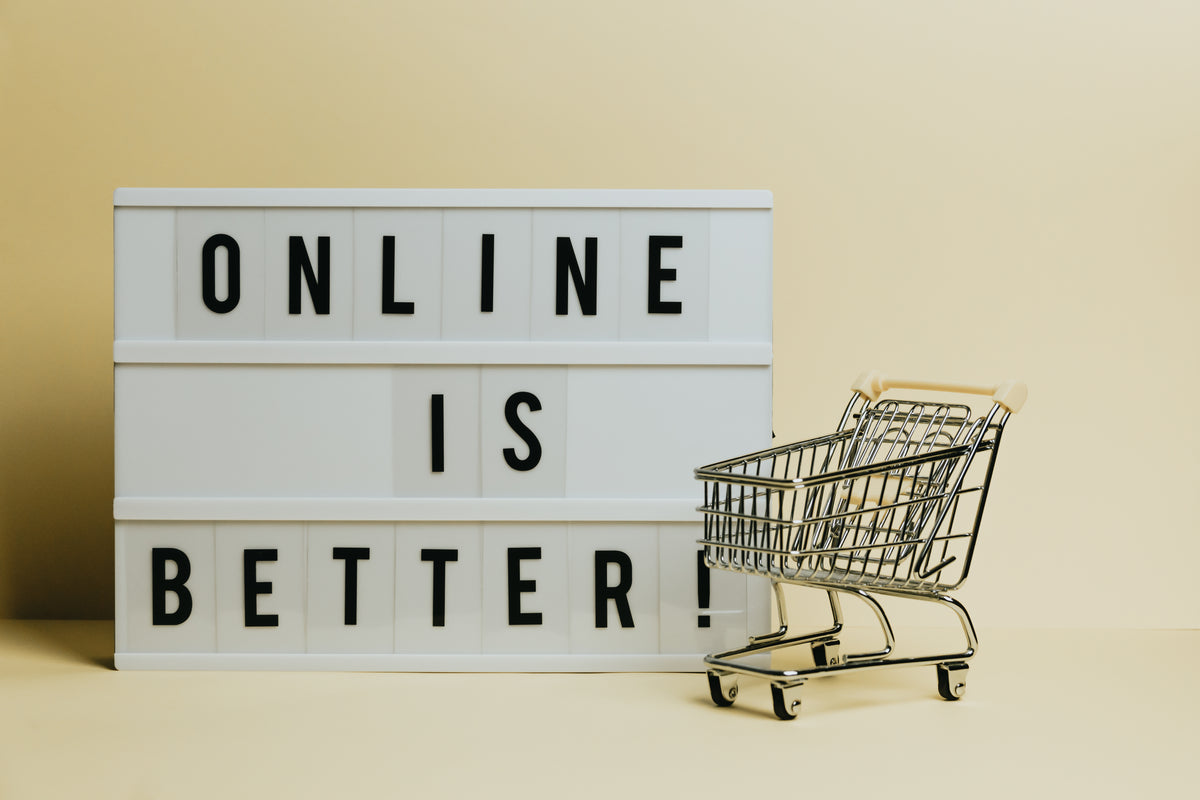sign says online is better with a small shopping cart