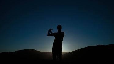 silhouette of a person against a starry night sky