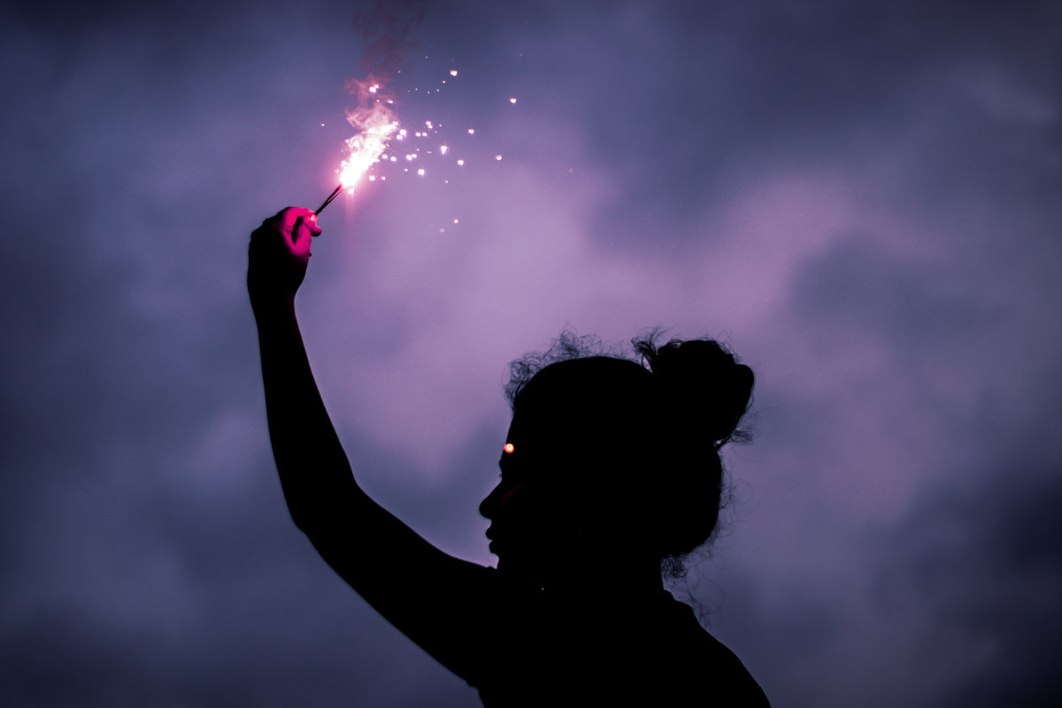 silhouette of a person surrounded by pink smoke