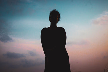 silhouette of a person with a sunset behind them