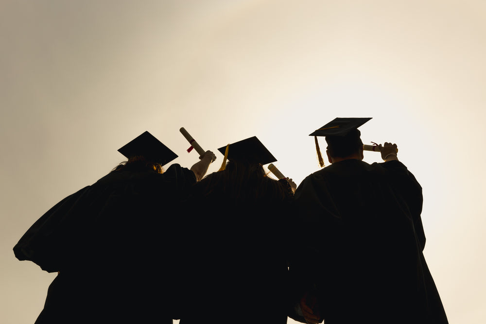 silhouette of three grad students