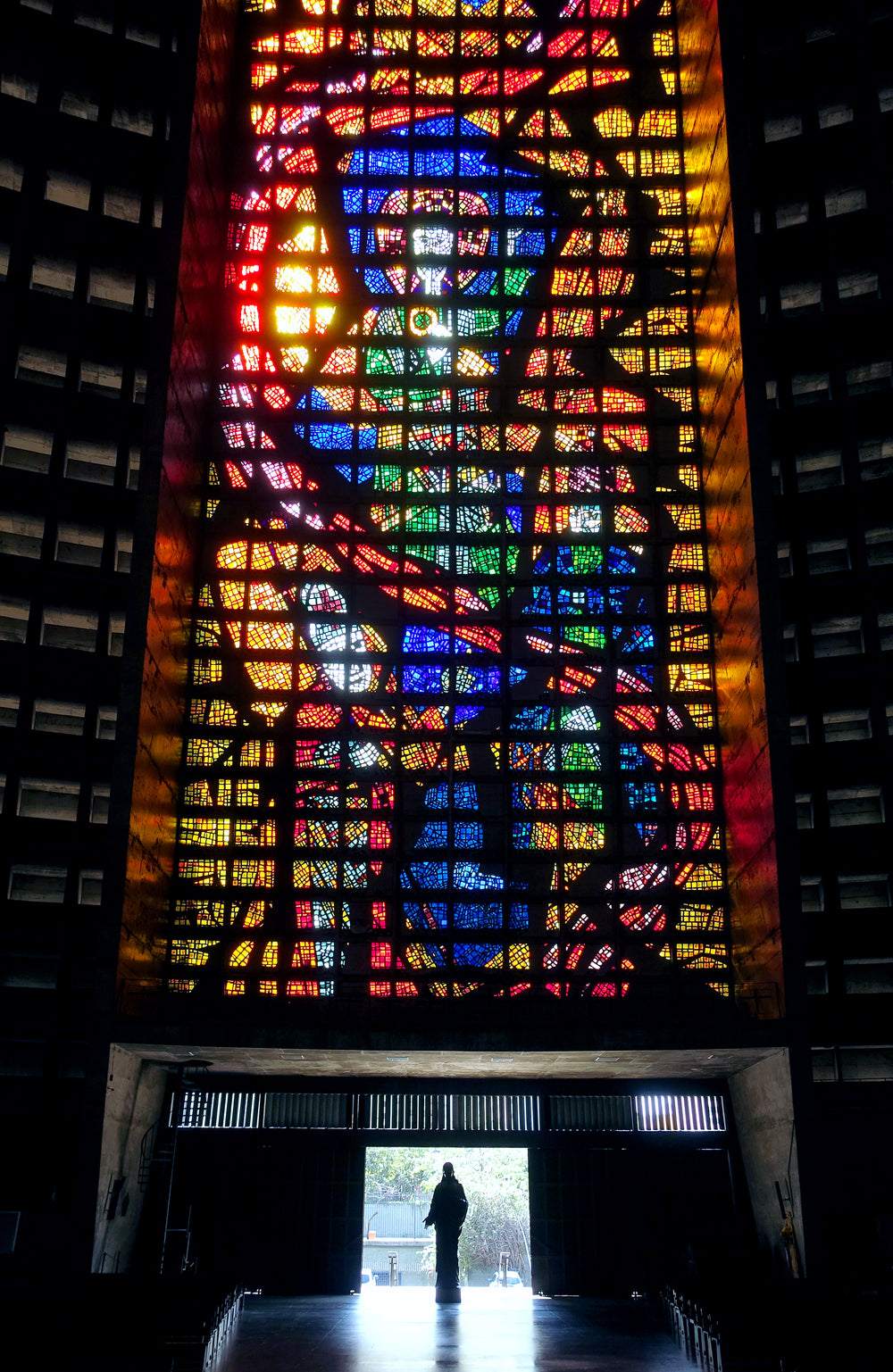 silhouette with a stained glass window above