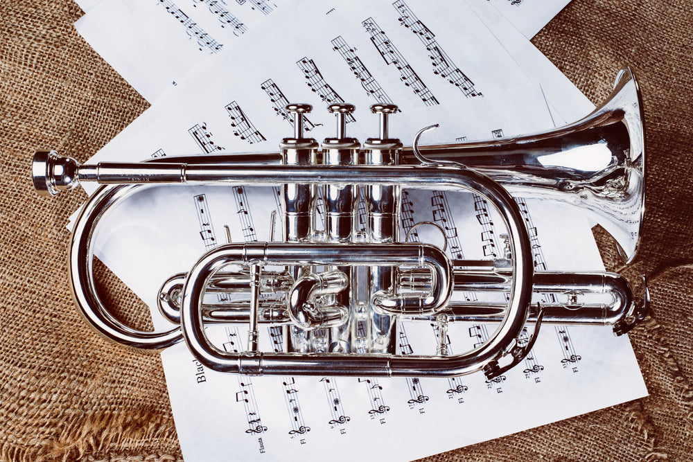 silver cornet instrument on sheet music