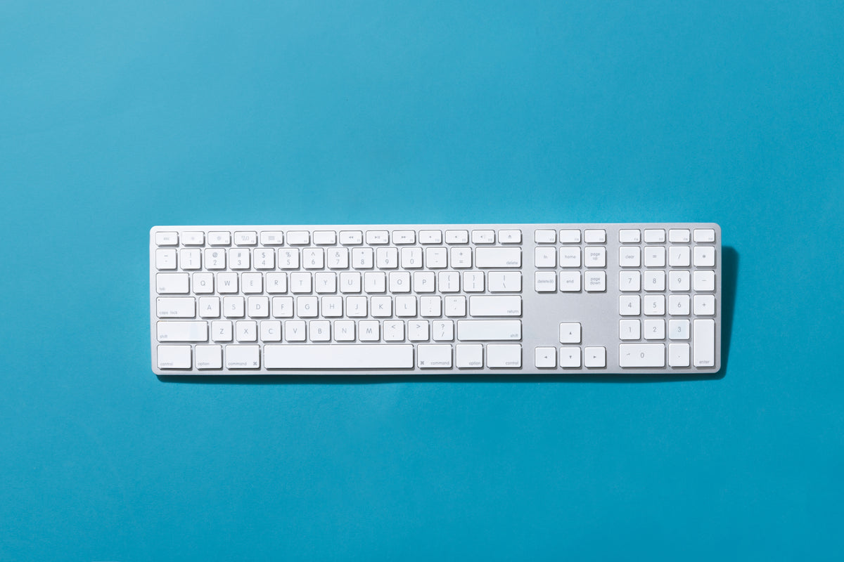 silver keyboard on blue background