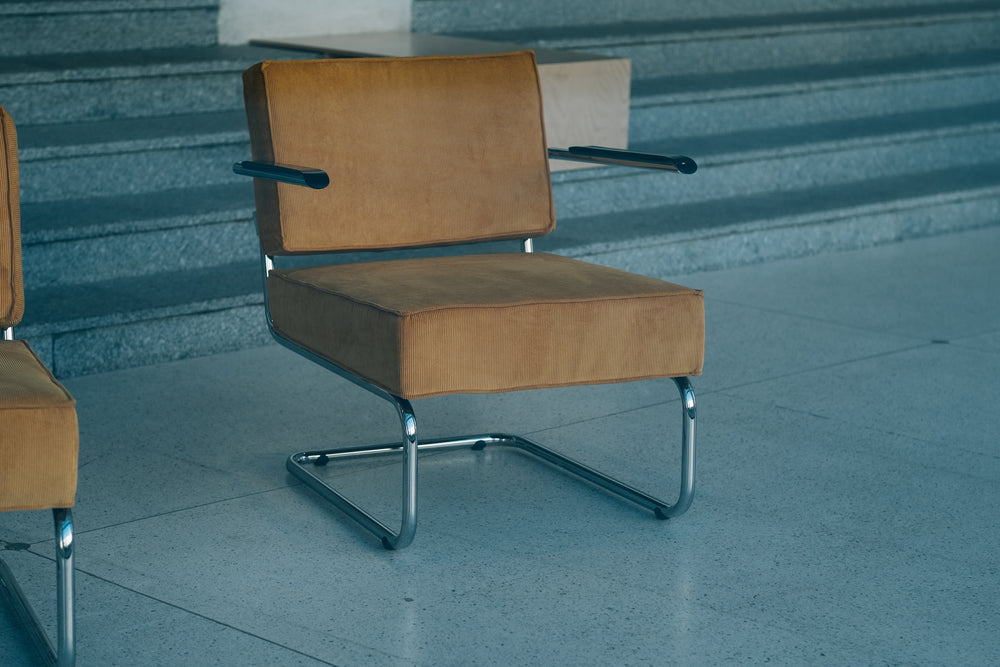 silver metal chair with thick yellow cushions