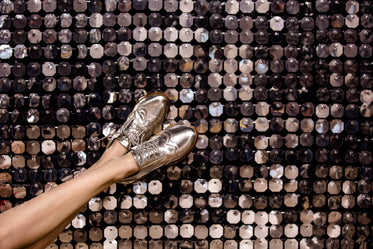 silver wingtip shoes on silver background