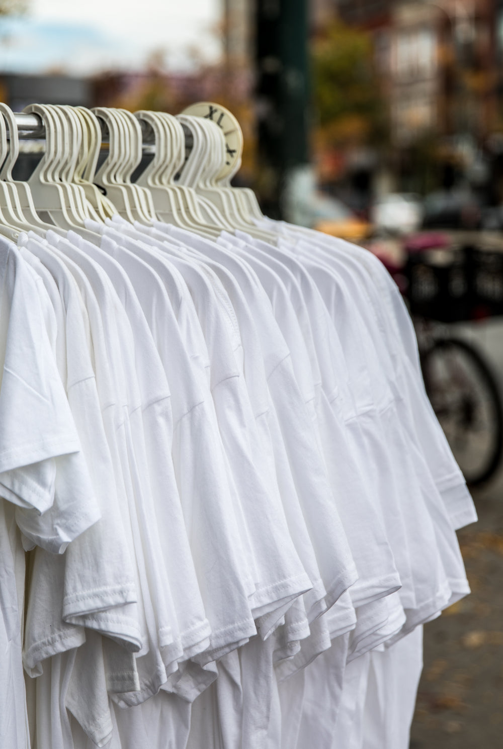 simple white shirts on shop clothing rack