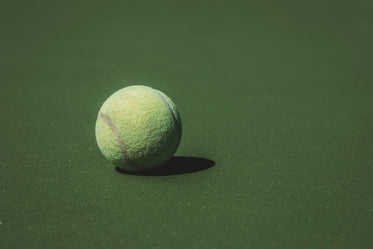 single tennis call casts a short shadow on the court